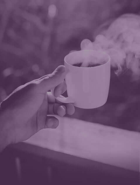 Hand holding a coffee cup